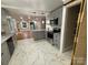 Updated kitchen with white and gray cabinets, granite countertops, and stainless steel appliances at 410 Gann St, Lowell, NC 28098