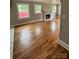 Bright living room with hardwood floors, a decorative fireplace, and large windows at 410 Gann St, Lowell, NC 28098
