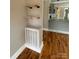 Open living space with hardwood floors, floating shelves, and white radiator at 410 Gann St, Lowell, NC 28098
