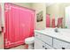 Bright bathroom features white vanity, toilet, and pink shower curtain detail at 7023 Blakeney Greens Blvd, Charlotte, NC 28277