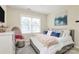 Well-lit bedroom with a comfortable bed, decorative pillows, and a stylish dresser with a television at 7023 Blakeney Greens Blvd, Charlotte, NC 28277