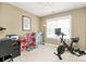 Spacious bedroom or flex room with Peloton exercise bike, desk, and dollhouse at 7023 Blakeney Greens Blvd, Charlotte, NC 28277