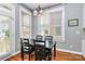 Bright dining area with large windows and an adjacent door to the outside at 7023 Blakeney Greens Blvd, Charlotte, NC 28277