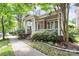 Attractive home with a spacious covered porch, brick detailing, and curb appeal in a tree-lined neighborhood at 7023 Blakeney Greens Blvd, Charlotte, NC 28277