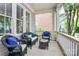 Relaxing front porch with wicker furniture and plush cushions, perfect for enjoying outdoor living at 7023 Blakeney Greens Blvd, Charlotte, NC 28277