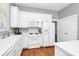 Well-lit kitchen features white cabinets, hardwood floors, and modern appliances at 7023 Blakeney Greens Blvd, Charlotte, NC 28277