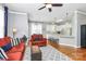 Comfortable living room adjacent to kitchen features hardwood floors and natural lighting at 7023 Blakeney Greens Blvd, Charlotte, NC 28277