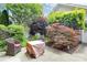 Private patio featuring mature landscaping and outdoor seating with fire pit at 7023 Blakeney Greens Blvd, Charlotte, NC 28277