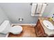 Powder room showcases a marble-topped vanity and hardwood flooring at 7023 Blakeney Greens Blvd, Charlotte, NC 28277