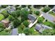 Aerial view of a home surrounded by mature trees and lush landscaping in a residential neighborhood at 10024 Tealridge Ln, Charlotte, NC 28277