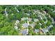 Aerial view of the property and neighborhood surrounded by mature trees in a well-established community at 10024 Tealridge Ln, Charlotte, NC 28277