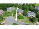 Aerial view of home on a cul-de-sac with mature trees, lush lawn, and neighborhing homes at 10024 Tealridge Ln, Charlotte, NC 28277