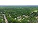 Aerial shot of the home in a neighborhood with mature trees and landscaping at 10024 Tealridge Ln, Charlotte, NC 28277