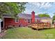 Spacious backyard with a brick home, patio, and lush green lawn, ideal for outdoor living at 10024 Tealridge Ln, Charlotte, NC 28277