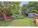 Well-maintained backyard with a garden, shed, and mature trees, perfect for enjoying nature at 10024 Tealridge Ln, Charlotte, NC 28277