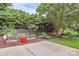 Serene backyard with raised garden beds and mature trees, creating a peaceful outdoor retreat at 10024 Tealridge Ln, Charlotte, NC 28277