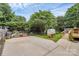 Large backyard featuring a shed, garden, and mature trees, perfect for outdoor activities at 10024 Tealridge Ln, Charlotte, NC 28277