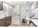 Modern accessible bathroom with new fixtures, grab bars and a glass enclosed shower at 10024 Tealridge Ln, Charlotte, NC 28277