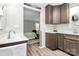 Modern bathroom with updated vanity and view into a bedroom with a light green bedspread at 10024 Tealridge Ln, Charlotte, NC 28277