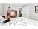 Charming bedroom featuring a comfortable bed with patterned quilt and a classic wooden desk with storage at 10024 Tealridge Ln, Charlotte, NC 28277