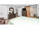 Comfortable bedroom with a sliding barn door leading to the bathroom and wood laminate flooring at 10024 Tealridge Ln, Charlotte, NC 28277