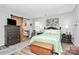 Comfortable bedroom features modern decor, a sliding barn door and wood laminate flooring at 10024 Tealridge Ln, Charlotte, NC 28277