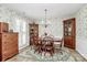 Charming dining room featuring floral wallpaper, wood furniture, and natural light at 10024 Tealridge Ln, Charlotte, NC 28277