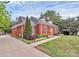 Beautifully landscaped red brick home with a well-maintained lawn and inviting walkway at 10024 Tealridge Ln, Charlotte, NC 28277