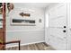 Welcoming foyer with neutral walls, wood-look floors, and decorative wall accents at 10024 Tealridge Ln, Charlotte, NC 28277