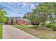 Spacious front yard featuring lush landscaping, mature trees, and a well-maintained lawn at 10024 Tealridge Ln, Charlotte, NC 28277