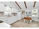 Bright kitchen with white cabinets, stainless steel sink, and a cozy breakfast nook at 10024 Tealridge Ln, Charlotte, NC 28277