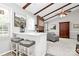 Bright living room with a brick fireplace, ceiling fan, breakfast bar and wood beam ceiling at 10024 Tealridge Ln, Charlotte, NC 28277