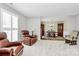 Inviting living room with soft carpeting and ample seating next to the dining area at 10024 Tealridge Ln, Charlotte, NC 28277