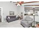 Bright living room with a wood beam ceiling, ceiling fan and access to the kitchen at 10024 Tealridge Ln, Charlotte, NC 28277