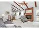Bright living room with a wood beam ceiling, brick fireplace and access to the kitchen at 10024 Tealridge Ln, Charlotte, NC 28277