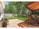 Enjoy outdoor living with a patio, wooden deck and lush green lawn at 1012 Lightwood Dr, Matthews, NC 28105
