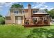 Backyard with wooden deck and gazebo, plus a brick chimney and brown siding at 1012 Lightwood Dr, Matthews, NC 28105