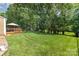 Expansive backyard featuring a lush green lawn with mature trees at 1012 Lightwood Dr, Matthews, NC 28105