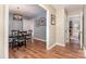 Inviting dining room with hardwood floors, chandelier, and access to multiple rooms at 1012 Lightwood Dr, Matthews, NC 28105