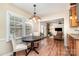 Bright dining room featuring natural light, chandelier, and views into the living room and backyard at 1012 Lightwood Dr, Matthews, NC 28105