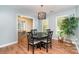 Dining area featuring modern chandelier, dark wood table, and natural light from windows at 1012 Lightwood Dr, Matthews, NC 28105