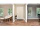 Bright foyer with hardwood floors, flanked by views of adjacent rooms and a decorative chair at 1012 Lightwood Dr, Matthews, NC 28105