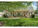 Charming home featuring a well-manicured lawn, inviting front porch, and attractive landscaping at 1012 Lightwood Dr, Matthews, NC 28105