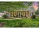Charming home with inviting front porch and manicured lawn, plus rocking chairs at 1012 Lightwood Dr, Matthews, NC 28105