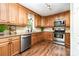 Well-equipped kitchen with stainless steel appliances, granite countertops, and maple cabinetry at 1012 Lightwood Dr, Matthews, NC 28105