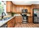 Modern kitchen showcasing stainless steel appliances, granite countertops, and custom cabinetry at 1012 Lightwood Dr, Matthews, NC 28105