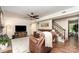 Inviting living room with a brick fireplace, stairs, hardwood floors, and comfortable seating at 1012 Lightwood Dr, Matthews, NC 28105