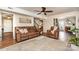 Spacious living room featuring hardwood floors, neutral walls, and comfortable leather furniture at 1012 Lightwood Dr, Matthews, NC 28105