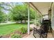 Inviting porch view featuring a classic rocking chair overlooking a lush green lawn at 1012 Lightwood Dr, Matthews, NC 28105