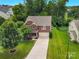 Aerial view of a brick two-story home with large driveway and lush green lawn at 1017 Quail Run Ct, Indian Land, SC 29707